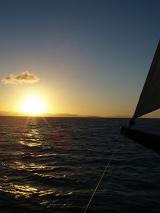 a sailing yacht at sunset, free to travel the globe with freedom