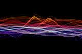 an abstract background image featuring colourful waves of light