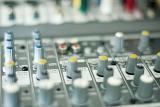 mixer controls on an audio mixing desk