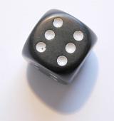 a black dice showing the number 6