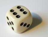 a white bone playing dice showing the number 6