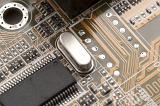 Close up detail on printed circuit board with resistors, capacitors, microprocessors and speaker