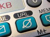 A close up of a blue URL button on silver organiser computer keyboard.