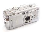 Old Canon Power Shot S45 silver digital compact camera with a slide to cover the lens viewed from the front high angle on white