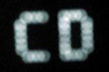 Blurred CD playing mode letters on display glowing from the dark