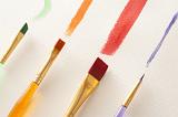 Close up of four single straight strokes of various colors and sizes from paintbrushes paintbrushes