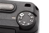 Close up of a camera aperture dial with f-stops 2.8 through 22 for controlling the shutter and light