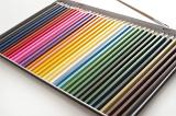 Open box with a large set of new colored pencil crayons for childhood creativity and art viewed at an oblique angle