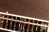 Wooden abacus lying on a desk or table viewed from overhead with copy space in a maths or accounting theme