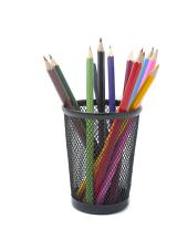 Multiple sharpened coloured pencils standing in a basket for drawing and sketching in an arts and crafts concept