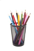 Colored pencils in black pencil holder isolated on white