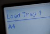 Load Paper digital display on a photocopier requesting that the user refill the paper tray