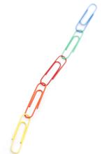 Chain made of colorful paper clips on white background