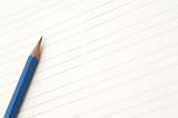 Sharp blue pencil on lined paper with space to place your message or text between the lines
