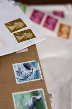 Shallow dof closeup of cancelled UK postage stamps on brown and white envelopes