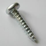 Metallic screw with helical ridge or external thread, high-angle close-up, with copy space on gray