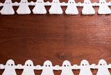 paper chain halloween ghost decoration forming a border with space for text in the middle