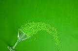 Green party concept with spilled drink decoration of a martini glass lying on its side and copy space above