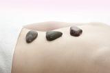 soothing lower back pain with a hot rock massage