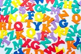 Brightly coloured scattered consonants inan education and learning background for teaching young preschoolers their alphabet